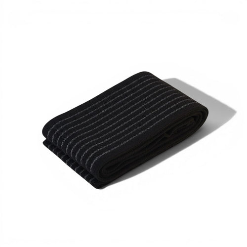 Padel Shark black elastic compression band with white stripes, offering optimal muscle support and injury prevention.
