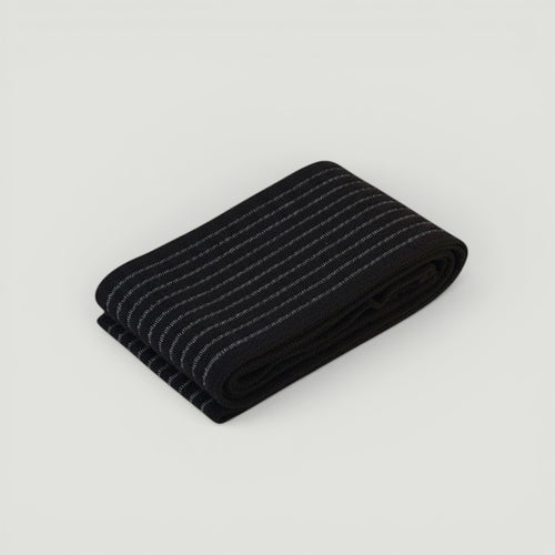 Padel Shark black elastic compression band with white stripes, offering optimal muscle support and injury prevention.